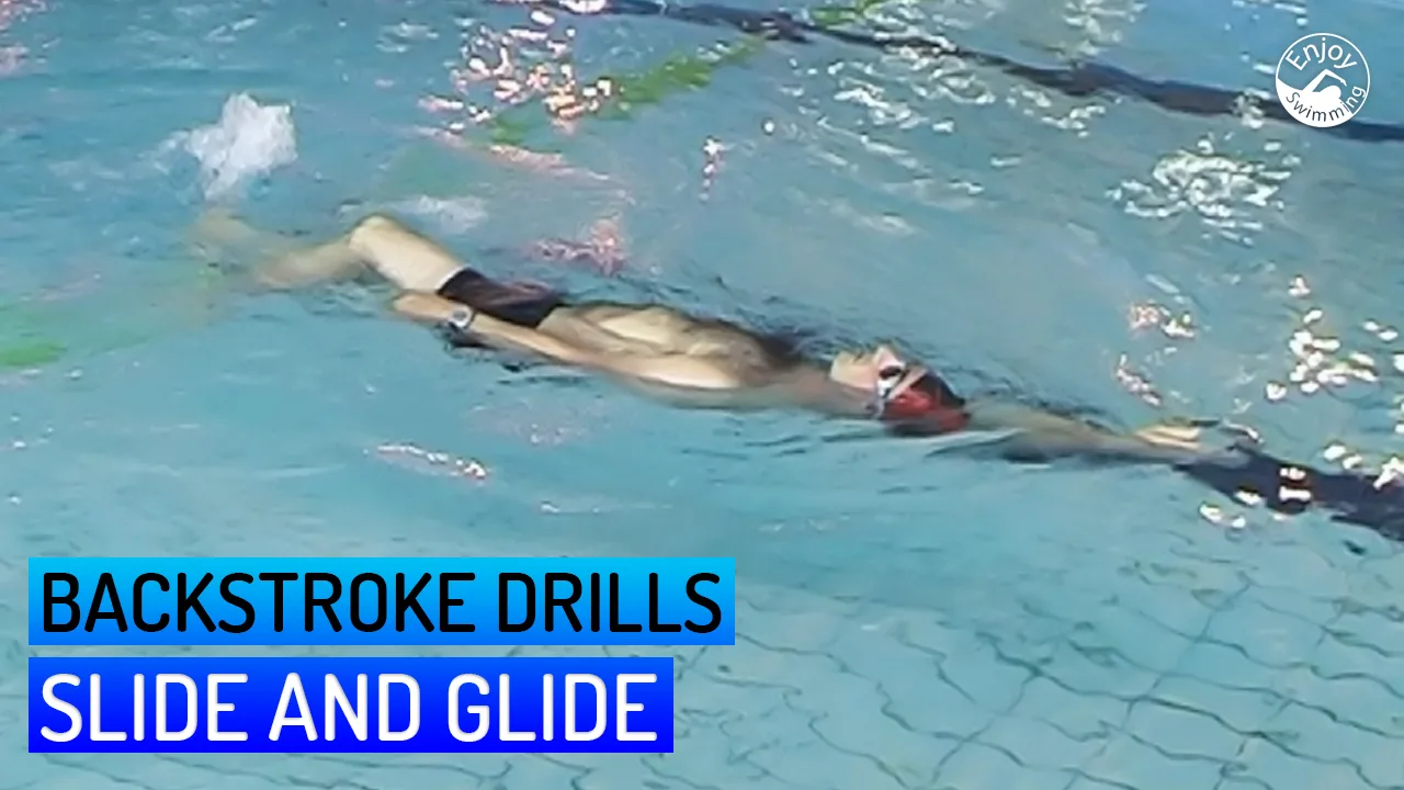 A novice swimmer practicing a slide and glide drill for the backstroke