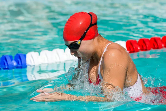 Picture of a female breaststroke swimmer breathing during the arm recovery phase.
