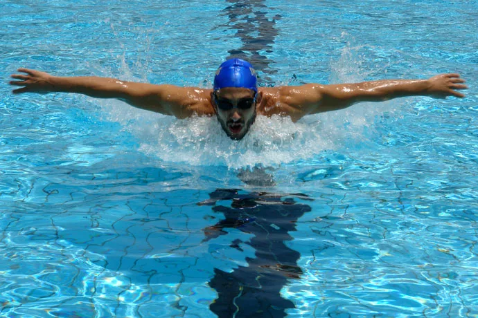 A butterfly stroke swimmer during the arm recovery phase.
