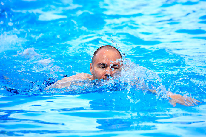 A man swimming dog paddle.