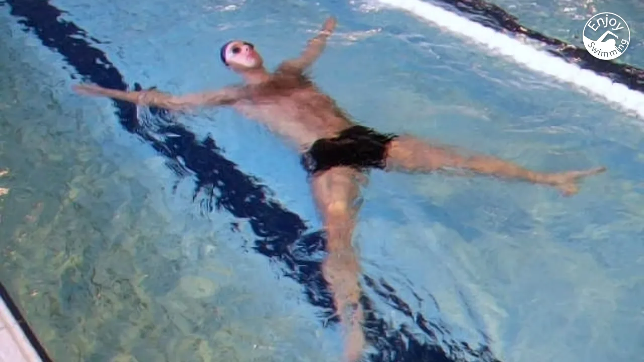 A swimmer demonstrates the elementary backstroke, on of the basic swimming techniques.