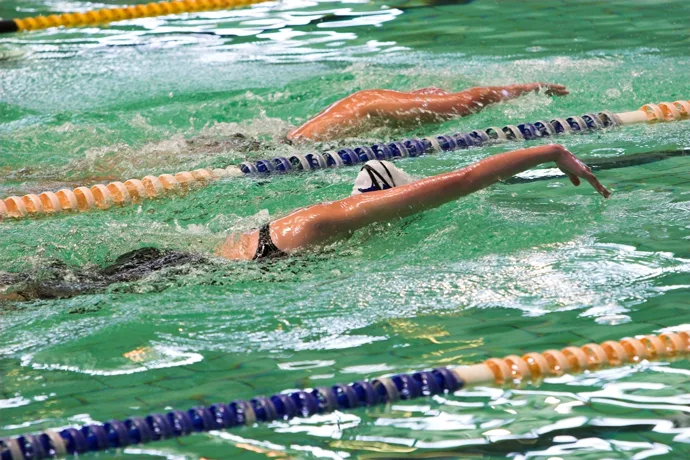 A freestyle swimmer who reaches too far forward during the arm recovery.