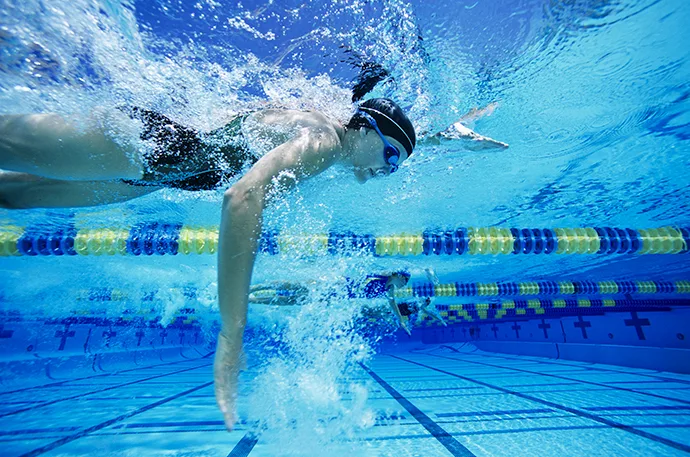 A freestyle swimmer is using a high-elbow position during the underwater arm pull.