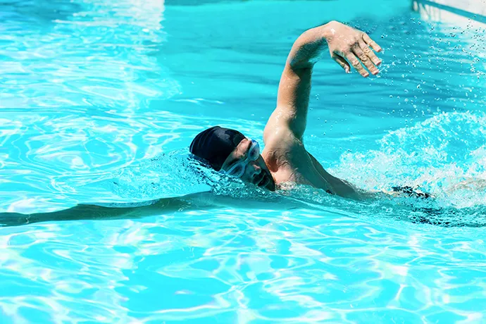 A freestyle stroke swimmer with a wide arm recovery