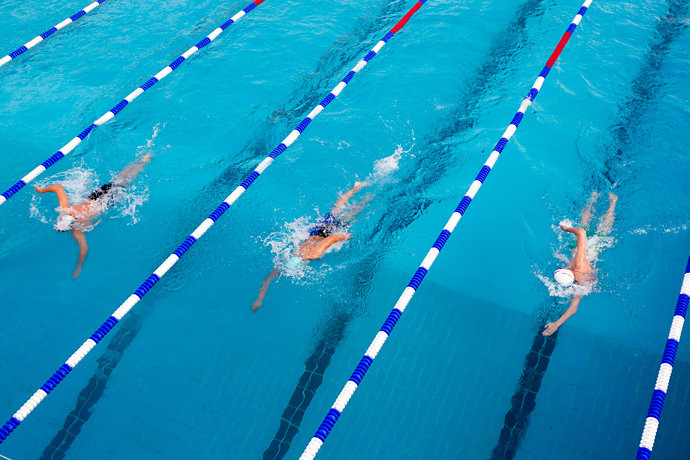 Three swimmers are racing in a long-distance freestyle swimming competition.