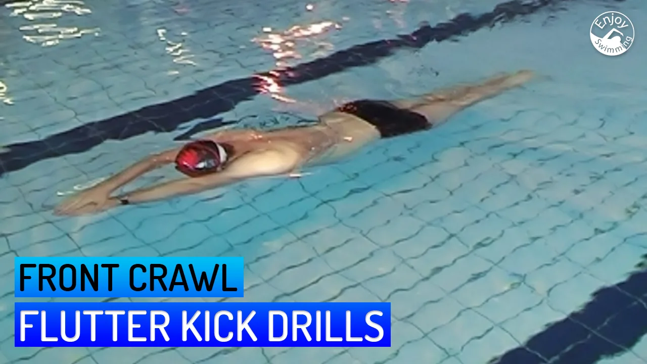A front crawl swimmer who practices swimming drills for the flutter kick.