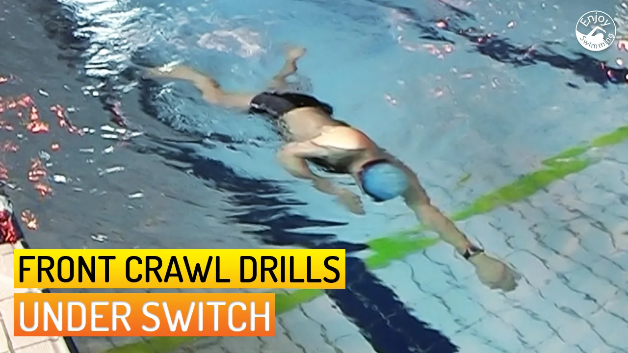 A novice swimmer who practices the under switch drill for the front crawl stroke.