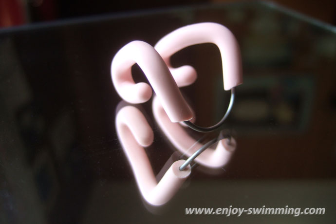 A simple nose clip with a wire-bound frame and latex padding.